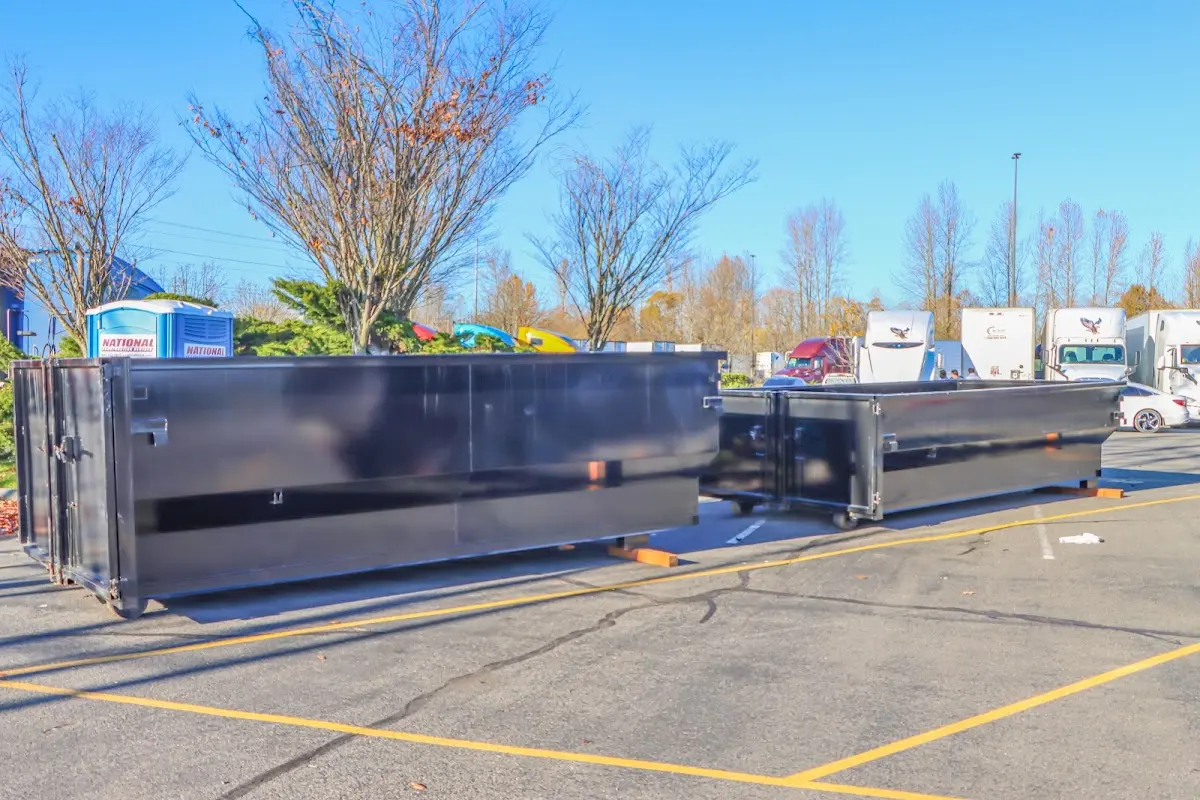 Professional dumpster rental service with roll-off container on residential driveway in Lower Gwynedd